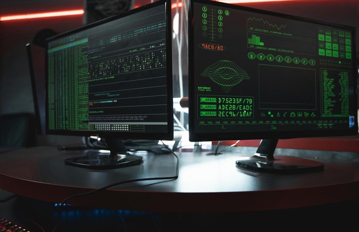 A pair of computer monitors displaying various dat